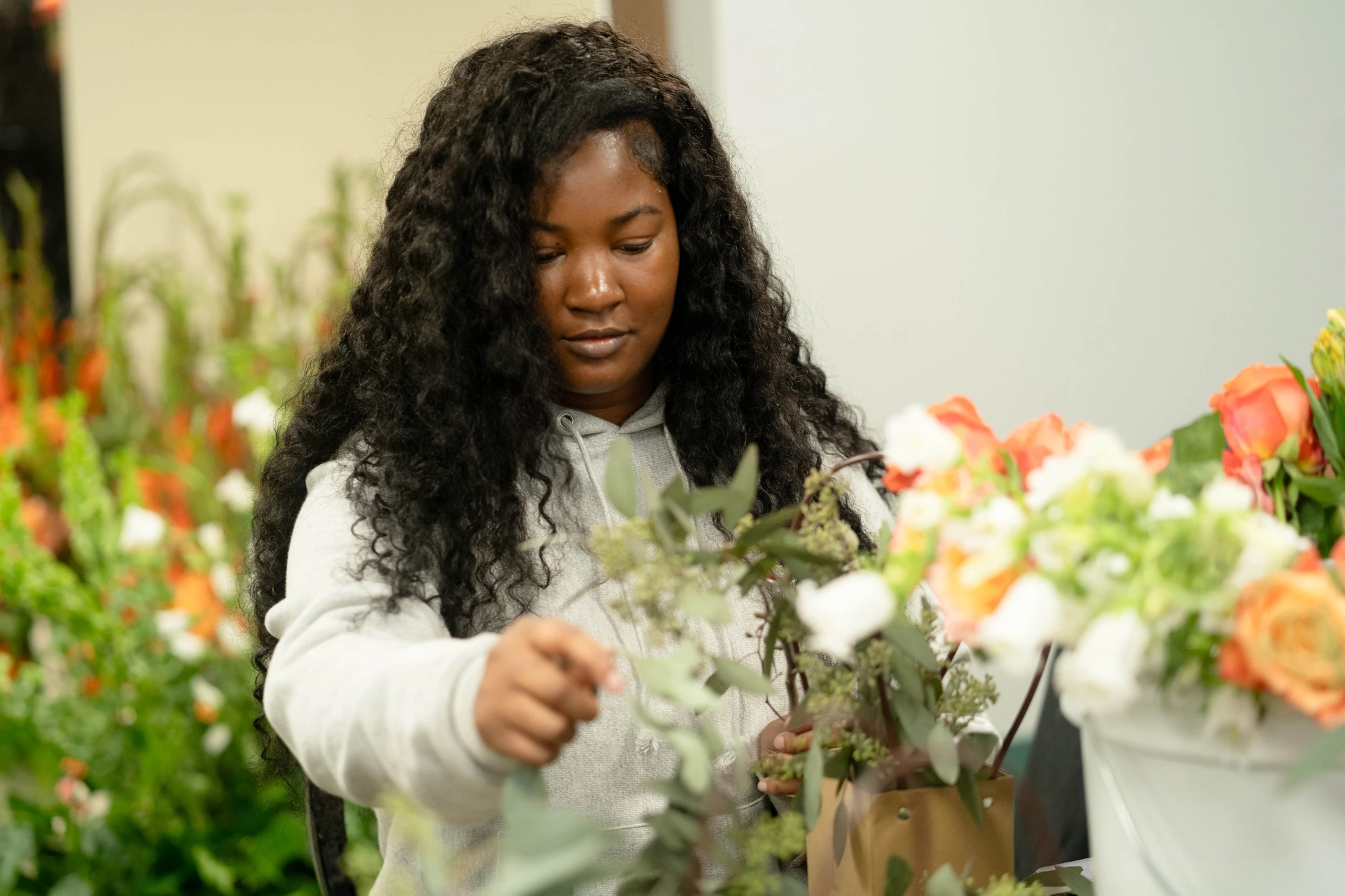 A guest creating a floral arrangement during the brand activation