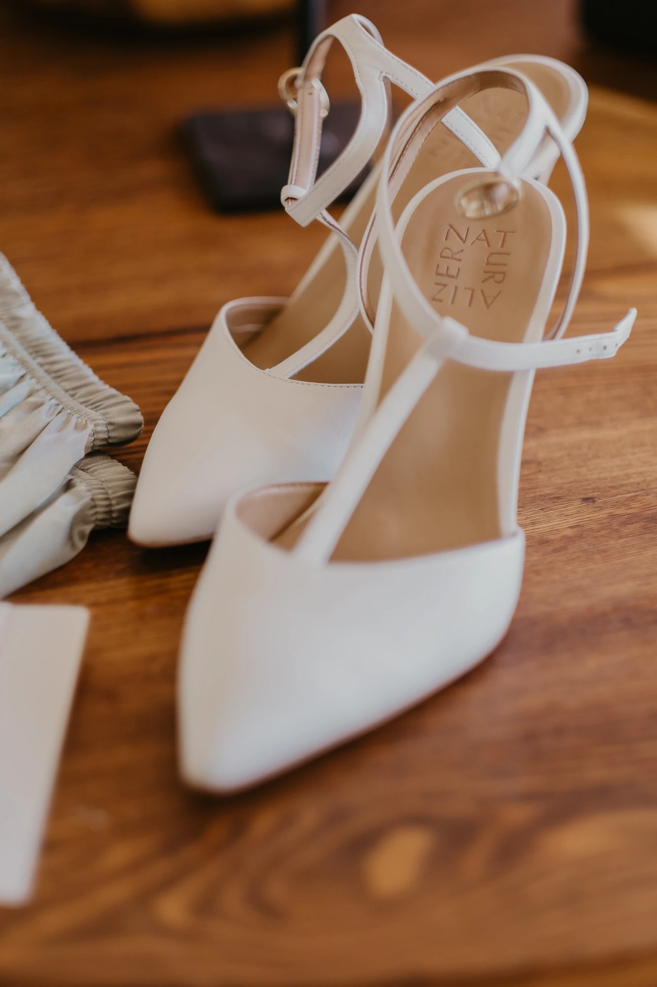 White bridal shoes photographed in warm light